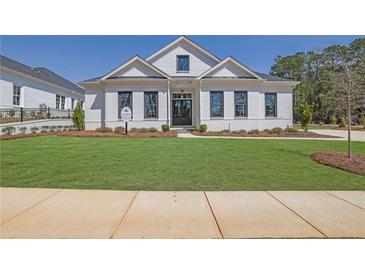 Beautifully landscaped front yard with a lush lawn and a charming white brick home at 123 Candler Loop, Acworth, GA 30101