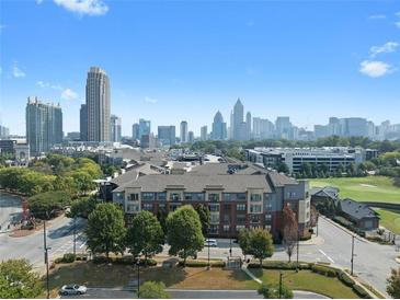 Stunning aerial view of the condominium complex with a backdrop of the city skyline and lush green surroundings at 400 17Th Nw St # 2218, Atlanta, GA 30363