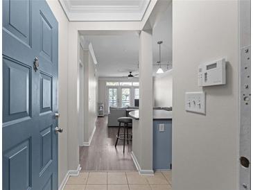 Welcoming entryway featuring a blue front door and leading to a living room with stylish decor and wood floors at 400 17Th Nw St # 2218, Atlanta, GA 30363