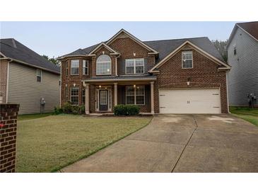 Charming two-story brick home with well-maintained lawn and a two-car garage at 4349 Sublime Trl, Atlanta, GA 30349