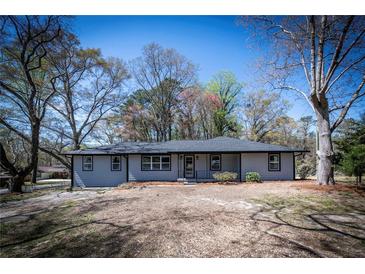 Charming one-story home with gray siding, dark roof, and well-maintained front yard at 6727 Kull Dr, Lithia Springs, GA 30122