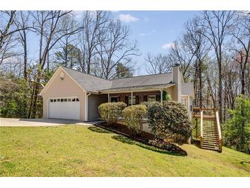 Charming ranch-style home featuring manicured lawn, attached garage, and a quaint front porch with inviting curb appeal at 263 Keller Dr, Mcdonough, GA 30252
