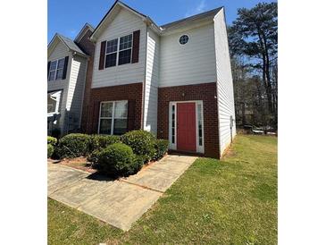 Charming two-story home with red brick accents and a well-manicured front yard at 257 Brookview Dr, Riverdale, GA 30274