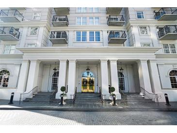 Grand building entrance with columns and stairs leading to the gold-trimmed doors at 195 14Th Ne St # 1908, Atlanta, GA 30309