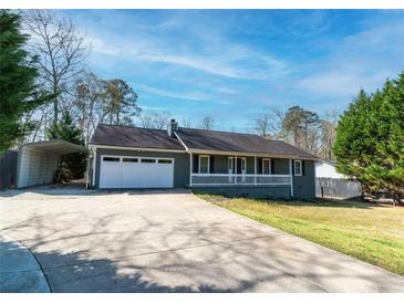 Charming single story home featuring an attached garage, a front porch, and a paved driveway at 11555 Brown Bridge Rd, Covington, GA 30016