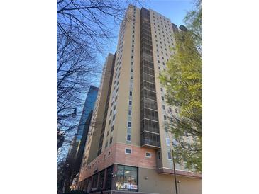 Exterior view of a high-rise building featuring multiple balconies and neutral color palette at 300 Peachtree Ne St # 17H, Atlanta, GA 30308