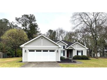 Charming single-Gathering home featuring a two-car garage and well-maintained landscaping at 3503 Saddlebrook Dr, Loganville, GA 30052