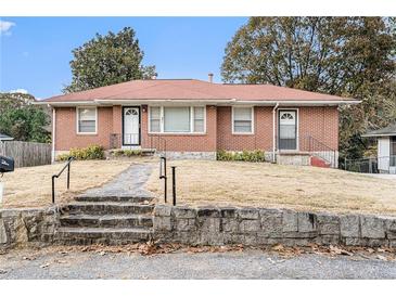Charming brick home featuring a red roof, stone steps, and a well-maintained front yard at 864 Northview Dr, Forest Park, GA 30297