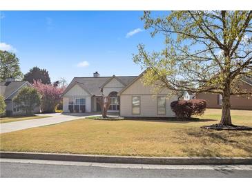 Well maintained single Gathering home with lush landscaping on a sunny day at 5330 Maltdie Ct, Sugar Hill, GA 30518