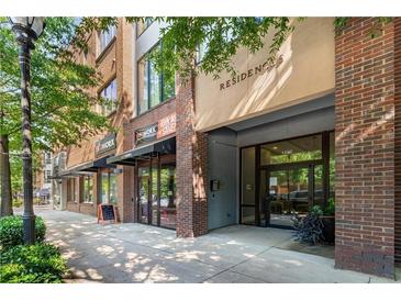 Facade of brick building featuring a private entrance for residences, and retail storefronts at 1430 Dresden Dr # 225, Atlanta, GA 30319