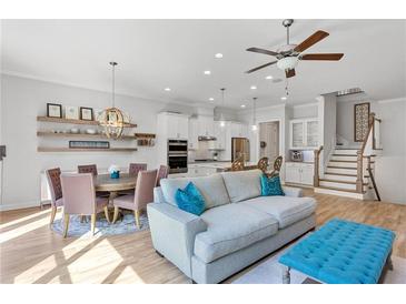 Bright living room boasts modern decor, an open floor plan, and a seamless transition into the dining and kitchen area at 2120 Sonoma Se Dr, Smyrna, GA 30080