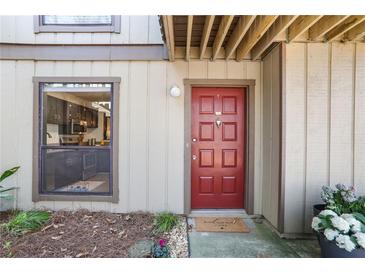 Welcoming front entrance with a red door and sidelight, plus a view into the modern kitchen at 210 Woodcliff Dr, Atlanta, GA 30350
