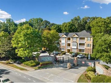 Bentley Place entrance with gated entry and mature trees on sunny day at 112 Bentley Pl, Tucker, GA 30084