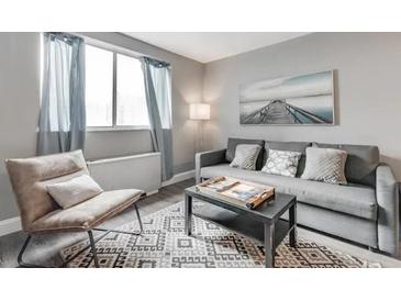 Cozy living room with neutral tones, stylish decor, and lots of natural light at 215 Piedmont Ne Ave # 904, Atlanta, GA 30308