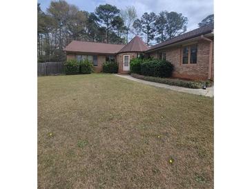 Charming single-story home featuring a well-maintained lawn and inviting curb appeal at 3348 Concord Se Cor, Conyers, GA 30013