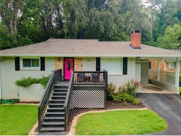 Charming single-story home with a brick chimney, pink door, and inviting front porch at 240 W Lake Nw Dr, Atlanta, GA 30314