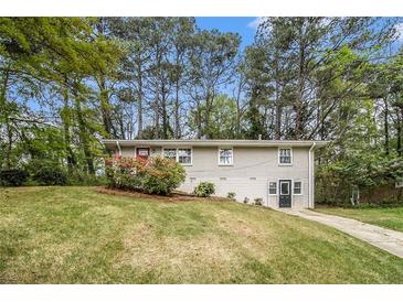 Charming split-level home featuring a freshly painted exterior and a well-manicured front yard at 3656 Tulip Dr, Decatur, GA 30032