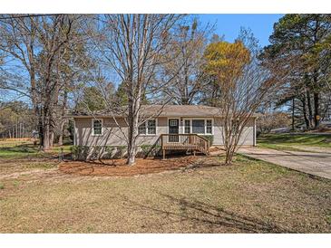 Charming single-story home featuring a well-maintained lawn and a quaint front porch at 10164 Sunny Sw Dr, Covington, GA 30014