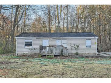 Single story home featuring a front porch with siding, surrounded by trees and an ample front yard at 355 Double D Rd, Temple, GA 30179