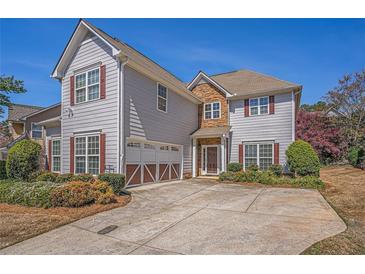 Charming two-story home with stone accents, red shutters, a two-car garage, and a well-manicured front yard at 2134 Shropshire Se Ln, Atlanta, GA 30316