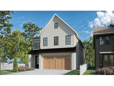 Charming two-story home with white siding, black trim, and a two-car garage with decorative wood doors at 2595 Apple Valley Rd, Brookhaven, GA 30319