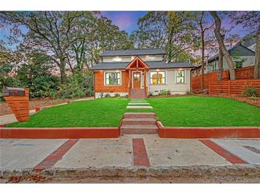 Charming exterior featuring a manicured lawn, stone walkway, and craftsman-style details at 3637 Elm St, Atlanta, GA 30354