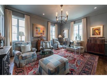 Elegant living room features a stylish chandelier, multiple seating areas, and beautiful hardwood floors at 2440 Peachtree Nw Rd # 1, Atlanta, GA 30305