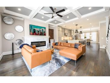 Spacious living room with a fireplace, modern sectional sofa, and an open floor plan at 1110 Briar Cove Cir, Atlanta, GA 30329