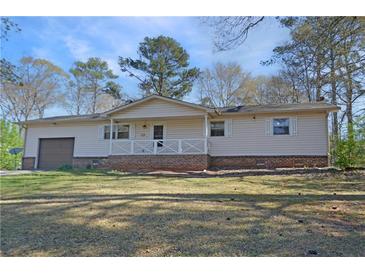 Charming single-story home featuring an integrated garage and inviting front porch at 3016 Deshong Dr, Stone Mountain, GA 30087