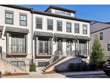 Beautiful townhome with crisp, clean exterior, including a brick facade and inviting entryway staircase at 2384 Provence Park Way, Decatur, GA 30033