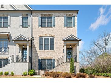 Charming townhome with a light brick facade, neat landscaping, and inviting front porch at 1949 Skyfall Cir, Brookhaven, GA 30319