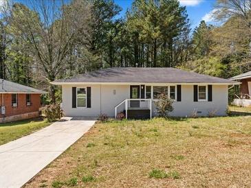 Charming single-story home with a well-maintained front yard and a driveway at 1703 Derrill Dr, Decatur, GA 30032
