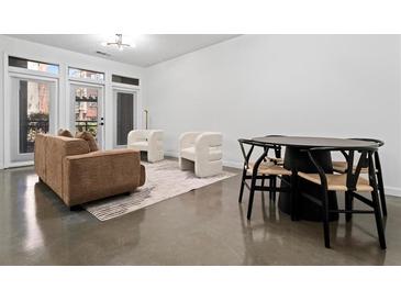 Modern living room with couch, chairs, table and doors to the outside at 400 17Th Nw St # 1133, Atlanta, GA 30363