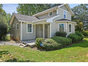 Charming two-story home with a front porch, beautiful bay window, and well-manicured landscaping at 1800 E Lake Rd, Mcdonough, GA 30252