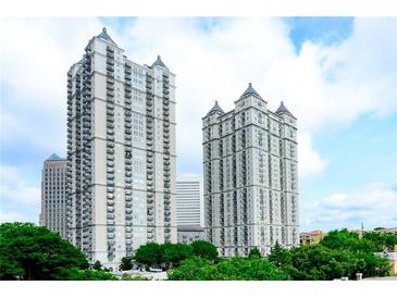 Stunning exterior view of two high-rise condo buildings with manicured landscaping and blue skies at 195 14Th Ne St # 2402, Atlanta, GA 30309