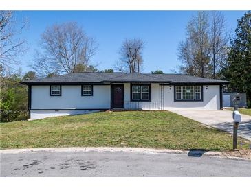 Charming ranch-style home with a well-manicured lawn and a classic, inviting facade at 54 Jean Ct, Hiram, GA 30141
