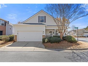 Charming home featuring a well-manicured lawn, a two-car garage, and a cozy front porch perfect for relaxation at 281 Hiawassee Dr, Woodstock, GA 30188
