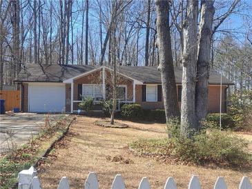 Charming brick ranch-style home with an attached garage and well-kept front yard at 359 Cedar Ridge Trl, Lawrenceville, GA 30046