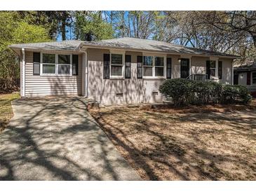 Charming single-story home with a brick facade, dark shutters, and a well-maintained front lawn at 2564 Brentwood Rd, Decatur, GA 30032