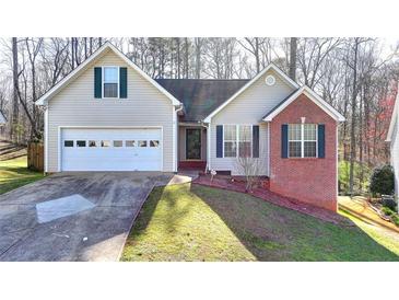 Charming single-Gathering home with a two-car garage, front lawn, and well-maintained landscaping at 4960 Markim Forest Ln, Sugar Hill, GA 30518