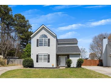 Charming two-story home featuring a well-maintained lawn, gray siding, and a freshly sealed driveway at 16 Montclair Ct, Cartersville, GA 30121