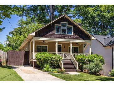 Charming bungalow featuring a cozy front porch, shingled gable, and well-maintained landscaping at 2628 White Oak Dr, Decatur, GA 30032