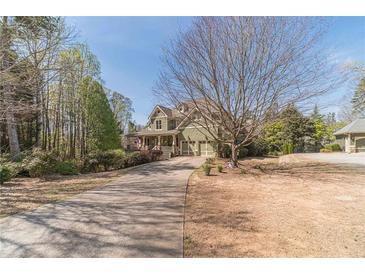 Charming two-story home featuring an attached two-car garage and a long private driveway at 3828 Morning Meadow Ln, Buford, GA 30519