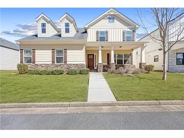 Charming two-story home with a welcoming front porch, well-maintained lawn, and stone accents at 5034 Little Harbor Way, Acworth, GA 30101