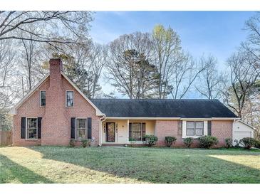 Charming brick home features mature trees, well-manicured lawn, and classic architectural details at 3189 Terramar Dr, Atlanta, GA 30341