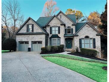 Charming two-story traditional home with manicured lawn and a two-car attached garage at 320 N Drew Ct, Duluth, GA 30097