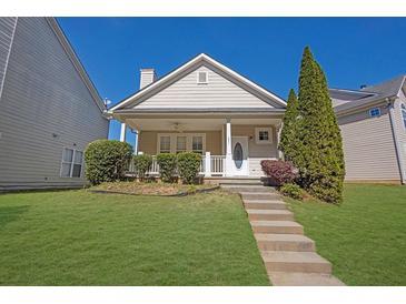 Charming home featuring a well-manicured lawn and inviting front porch at 4571 Parkway Cir, Atlanta, GA 30349
