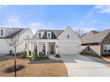 Charming single-Gathering home featuring a well-manicured lawn, a two-car garage, and a welcoming front porch at 1929 Finnish Ln, Kennesaw, GA 30152