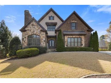 Beautiful two-story home with a combination of stone and brickwork, plus a well-manicured lawn at 2814 Adams Oaks Ln, Marietta, GA 30062