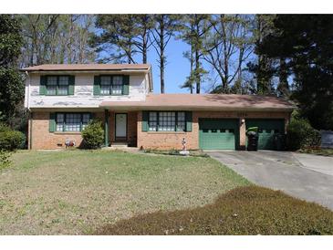 Charming brick home with a two-car garage and a well-maintained front yard at 3274 Jodeco Pl, Jonesboro, GA 30236